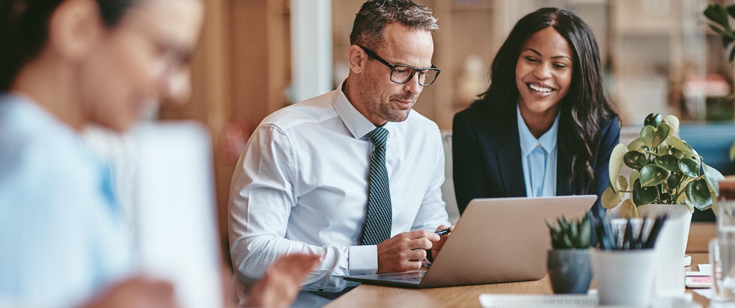 Two business workers using laptop