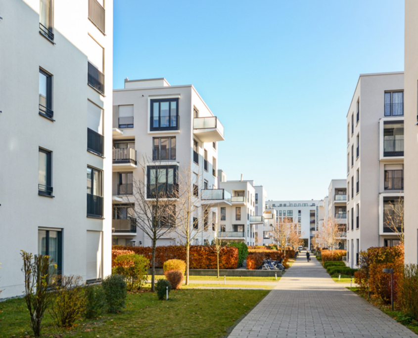 Side view of sidewalk next to renovated apartment complex