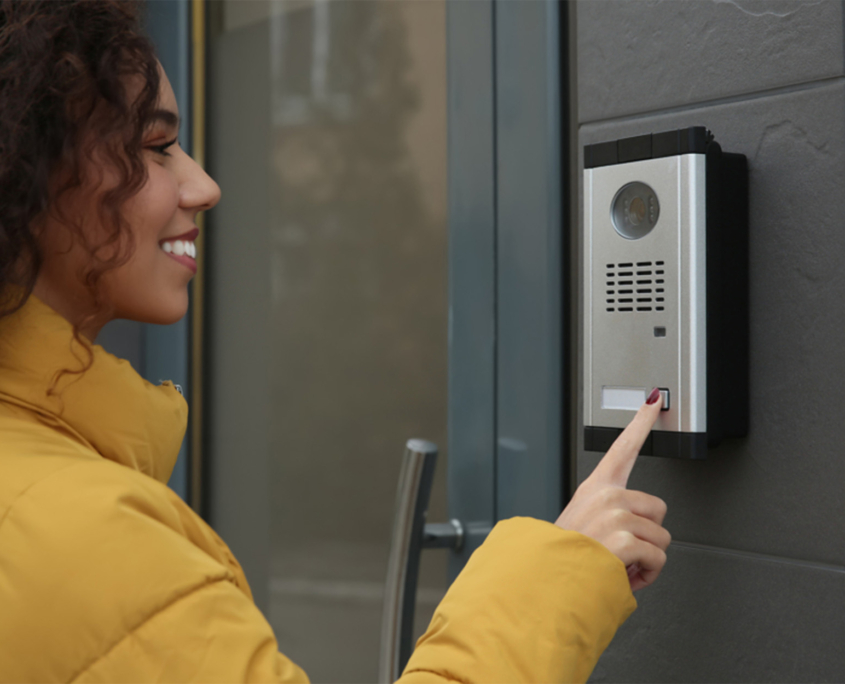 Woman Pressing Button to Get into Commercial Building