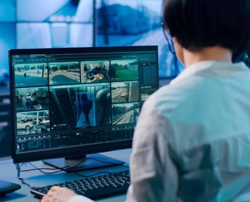 Female security personnel looking over surveillance footage