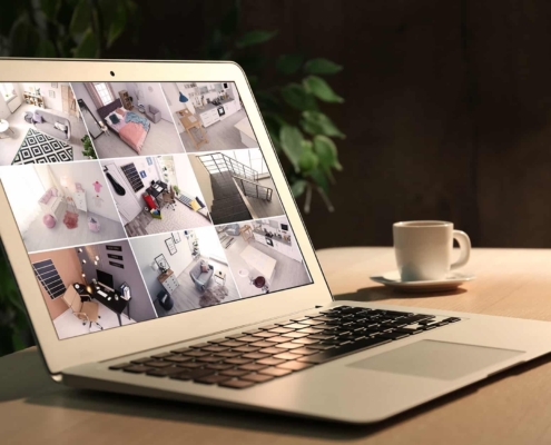 Side view of a computer with security camera footage on the screen