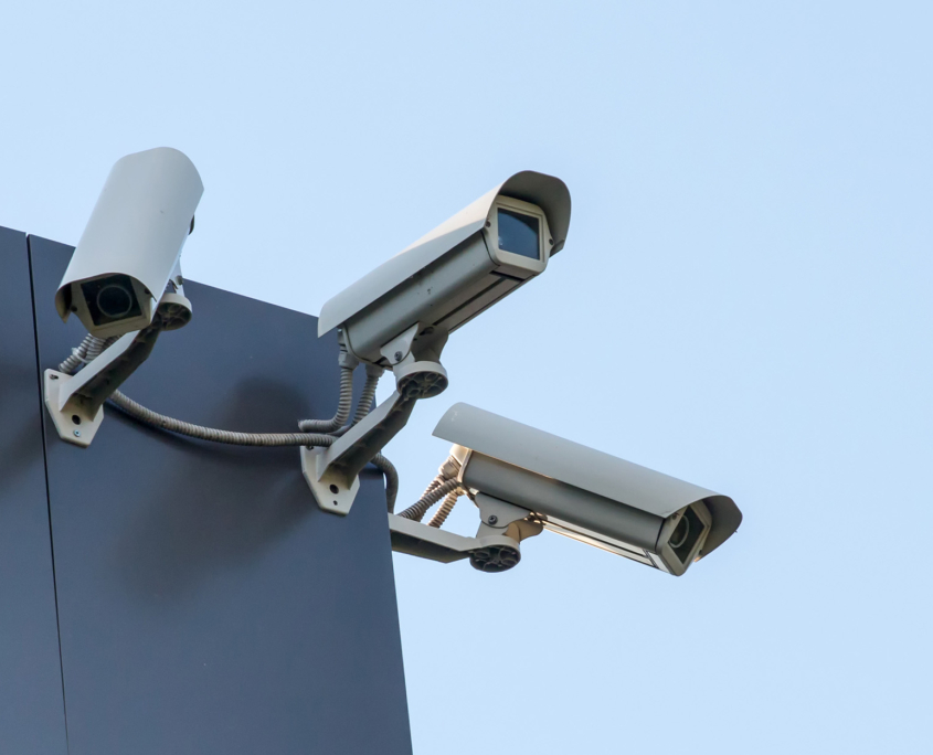 Side view of security CCTV cameras pointed in different directions on corner of building