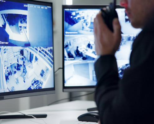 Male security guard, radio and speaking by cctv monitor for protection