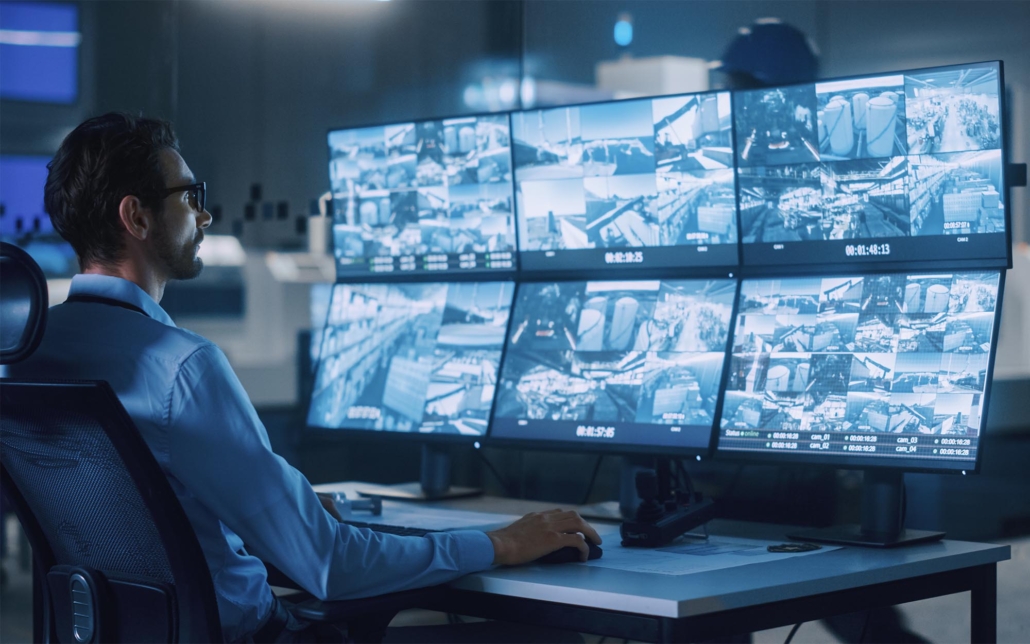 Tech professional checking video surveillance on computer
