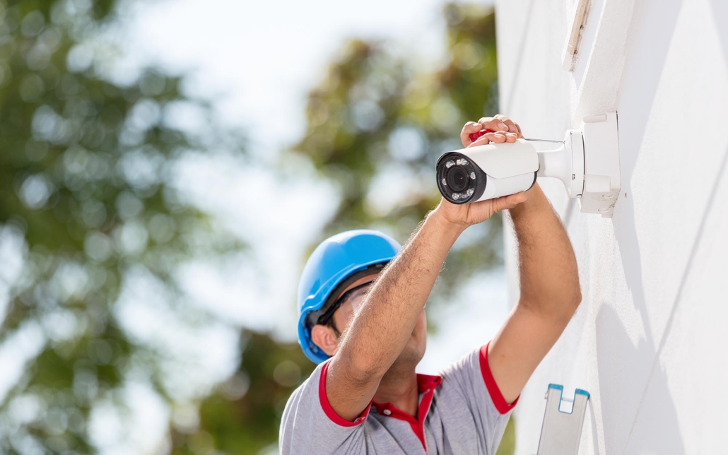 Worker installing security camera