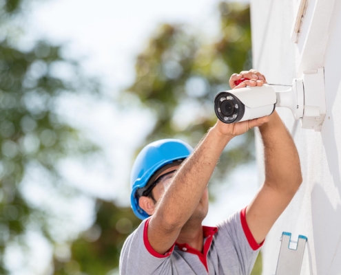 Worker installing security camera