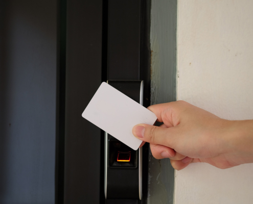 Door access control with a hand inserting key card to unlock door