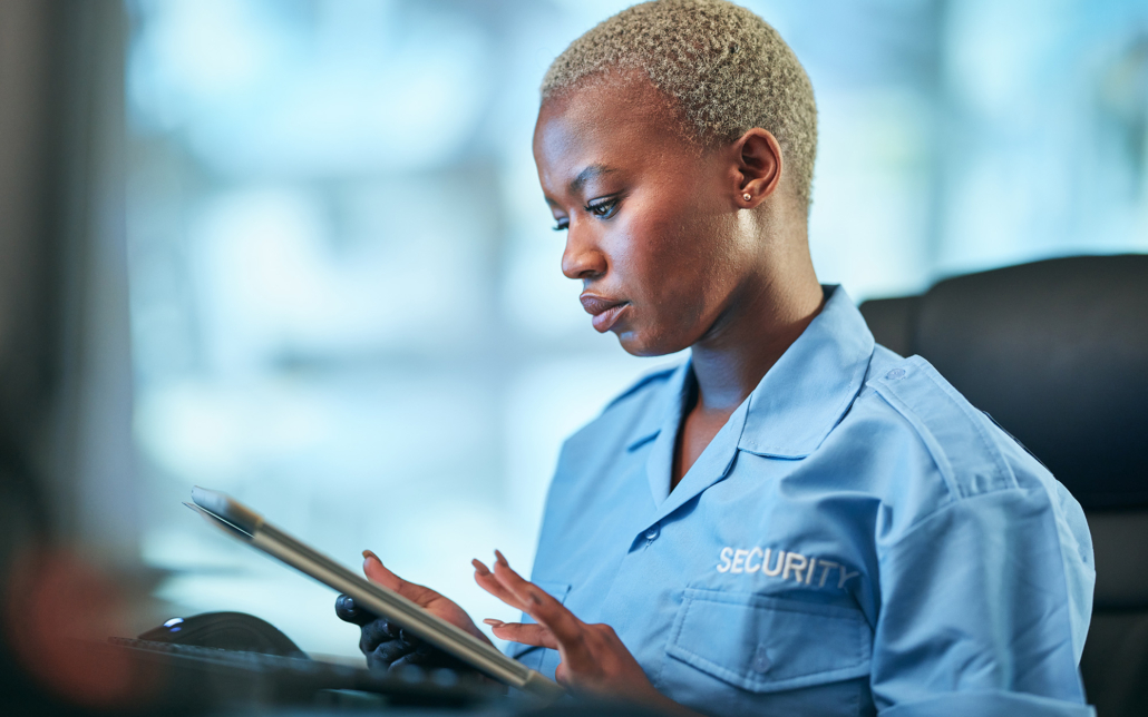 Security, working and black woman with tablet at a desk for communication