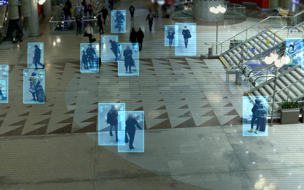 Security camera view with AI detection boxes on human figures