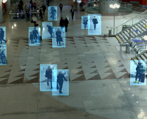 Security camera view with AI detection boxes on human figures